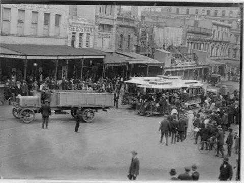 Large crowd watching truck in front of North Carlton tram, 1902–20