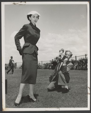 Portrait of Norman Ikin photographing model at Caulfield races, 1950–54