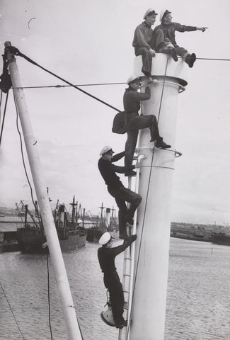 Cadets on Cadet ship Durham [?] climb a Sampson Post for a view of Melb[ourne], c. 1947