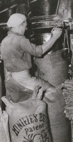 Filling sacks of flour at a Melbourne flour mill to help alleviate Britain's food shortage, c. 1946