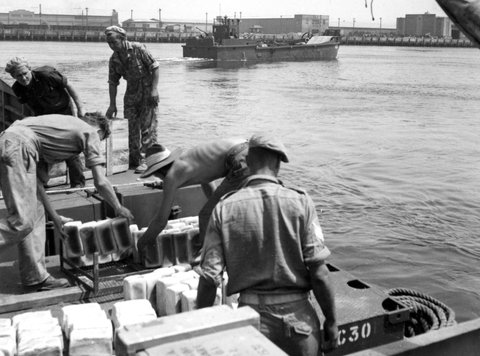 One of the new 106 ft invasion barges built at Geelong, leaving a Port Melbourne dock for operational waters, c. 1945