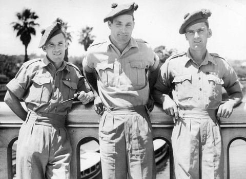 Three members of the Black Watch famous Scottish regiment on leave for the day sightseeing in Melbourne, snapped on Princes Bridge, c. 1944