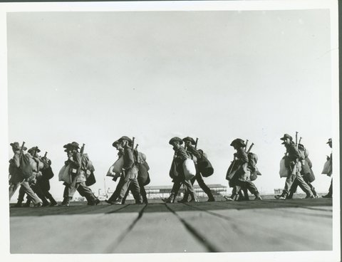 [Soldiers] marching along pier at Port Melbourne before embarking, 1940