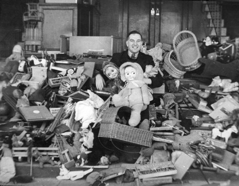 Mr. Brown amidst a pile of toys donated by the children of Preston, c. 1944