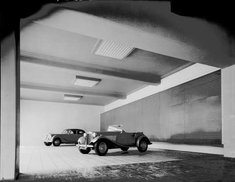 [TD model MG and Rile 2.5 litre saloon, ca. 1950 vintage in the basement of Lane's Motors, Exhibition Street, Melbourne]