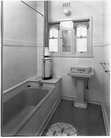 Bathroom interior, showing bath, pedestal basin, and gas bath heater in a completed house on the Coburg Housing Estate, c. 1949