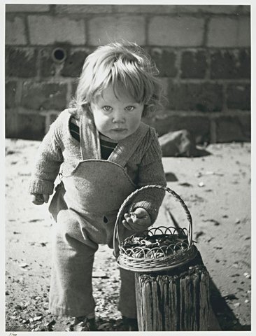 Sweeney eating chocolate, Martin Street beach, Elwood, 1946