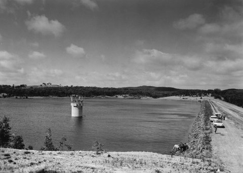 McCay Reservoir with embankment and name and information board, 1960–63