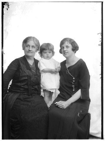 Studio portrait of probably three generations of the Hampton family, grandmother on left, mother on right and child in centre, 1920–30