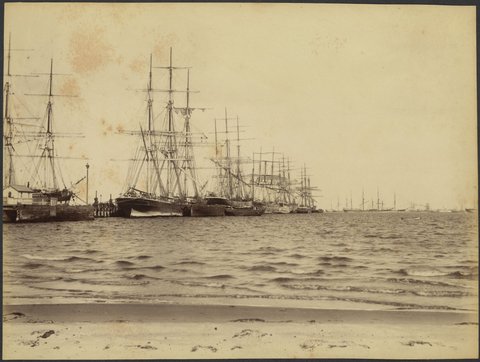 View from the beach of sailing ships at wharf and in the bay, possibly Port Melbourne and Port Phillip Bay, 1888?