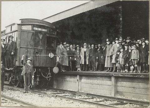 Electrification of section, Ringwood to Upper Fern Tree Gully First Train.12.10.1925. [Viewed from across the tracks with train in foreground.]
