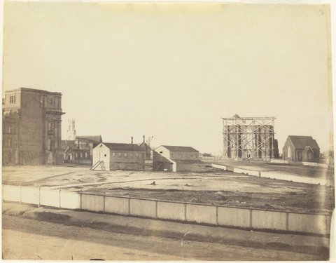 Eastern Hill. View of German Church, St. Patrick's Cathedral, Parliament House St. Peter's Church. Schools being newly roofed from Spring St [Melbourne], 1861