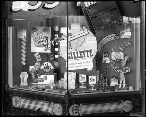 Tobacconist's and barber's display windows, 5 Fitzroy St., St. Kilda, 1948