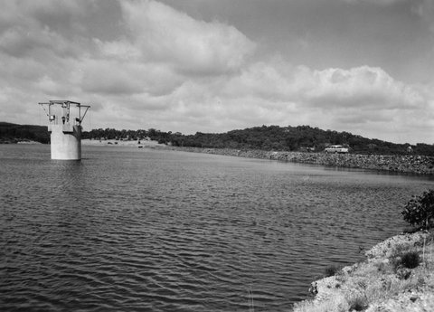 McCay Reservoir with embankment and name and information board, 1960–63