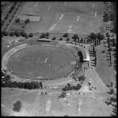 Aerial view of Carlton football ground and sports field, looking north, 1954
