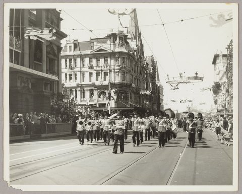 Marching band at corner of Collins and Swanston Street, 1954