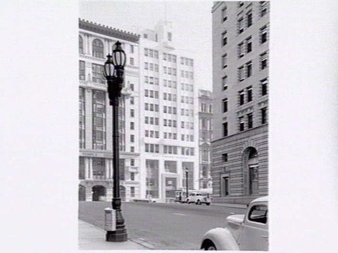 Collins Street from Market Street, showing Temple Court building 422-8 Collins Street, Royal Insurance building 414-8 Collins Street, and side of AMP Chambers, 419-25 Collins Street, c. 1940