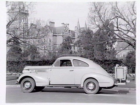 Pontiac All Enclosed Coupe (Sloper), auto gas producer fitted for use during wartime, outside Ormond College Melbourne University, 1940?