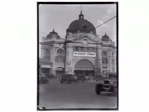 Flinders Street Station with cars and sign "The Railway Nursery", 1914–33