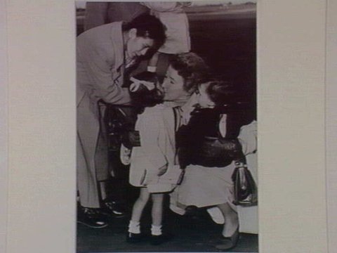 Gordon Parker's mother, Mrs. Venn Parker, greets her grandchildren at Essendon Airport July 1952