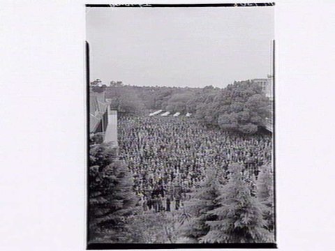 Large numbers of people placing bets at Flemington Racecourse, 1949