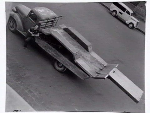 Looking down on a man standing beside a truck belonging to Alfred H. Wall, Window Frame Manufacturer, 8 Tinning Street, Brunswick, c. 1941
