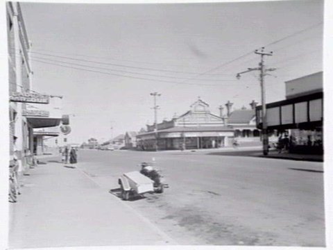 Bell St., Preston, at intersection with Plenty Rd. Laidlaws' grocery on corner at 233 Bell St, c. 1949