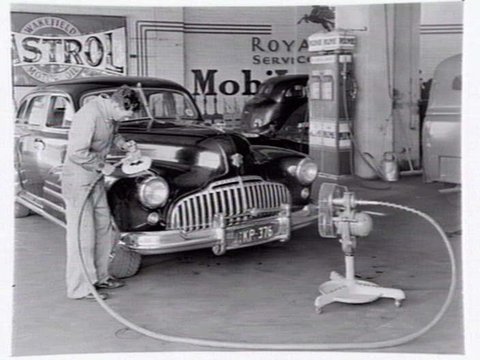 Buick being polished and buffed at Royal Park Service Garage, 411 Flemington Rd., North Melbourne, 1950