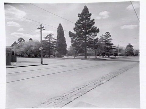 View down High Street, Malvern, the Malvern public gardens, and State School on corner of High Street and Spring Road, Malvern, c. 1950