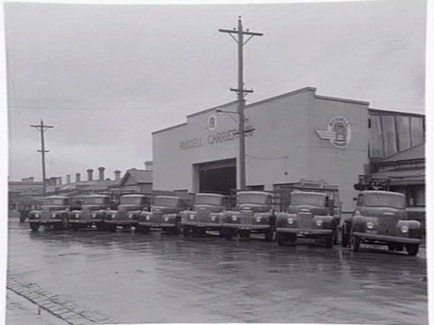 Exterior, Russell Carriers, Pty. Ltd., 235 Ross Street, Port Melbourne, with fleet of trucks outside, c. 1952