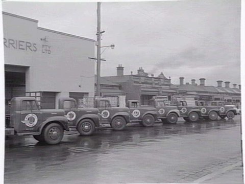 Exterior, Russell Carriers, Pty. Ltd., 235 Ross Street, Port Melbourne, with fleet of trucks outside, c. 1952