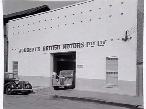 Joubert's British Motors P/L, Chessel St., South Melbourne, showing outside and mechanics at work inside, c. 1953