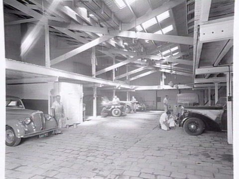 Joubert's British Motors P/L, Chessel St., South Melbourne, showing outside and mechanics at work inside, c. 1953