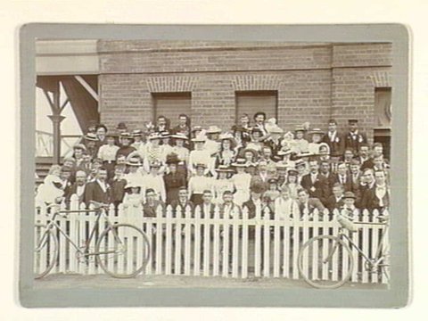 Group portrait of men, women and children, possibly Cheltenham Cycle Club members and families, c. 1897