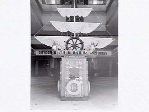 Decorations at the Capitol Theatre, Swanston St., Melbourne, for the film 'Down to the Sea in Ships', including posters or paintings and ships rigging at the ticket box, 1949