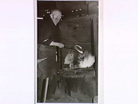 [Mr. M. McKenna, blacksmith of Brighton, shown at his forge], c. 1938