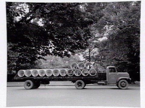 Truck from Humes Limited, 114 King Street, Melbourne, loaded with pipes, 1950?