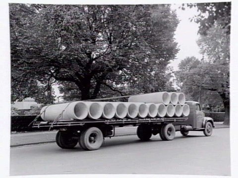 Truck from Humes Limited, 114 King Street, Melbourne, loaded with pipes, c. 1950