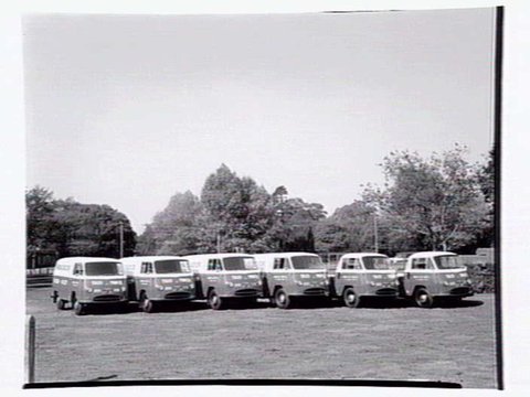 Fleet of vans from the Ambassador Hire Service, 27 Little Bourke St, 1938