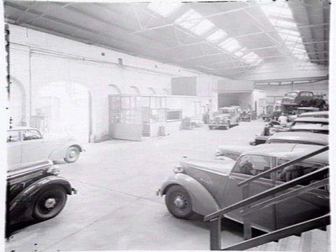 Joubert's British Motors, 566-8 Bourke St., Melbourne, showing exterior and cars in showroom, 1948