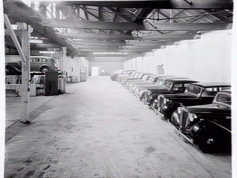 Joubert's British Motors, 566-8 Bourke St., Melbourne, showing exterior and cars in showroom, 1948