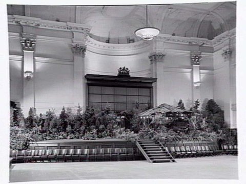 South Melbourne Town Hall, stage area decorated with plants and bark roofed hut, 1950?