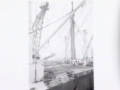 Melbourne Harbour Trust 40 ton floating crane lifting a boiler onto or from a low loader at wharf, 1949