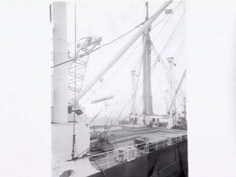 Melbourne Harbour Trust 40 ton floating crane lifting a boiler onto or from a low loader at wharf, 1949