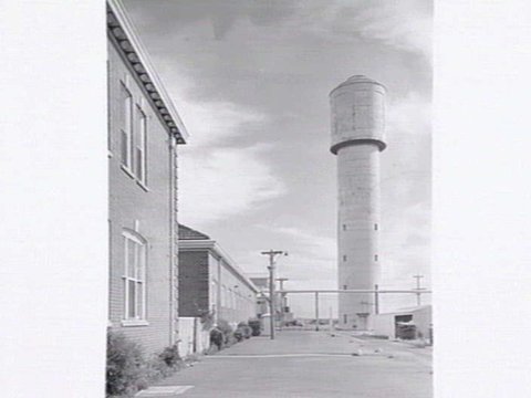 Monsanto Chemicals, Sommerville Rd., Braybrook, showing workers arriving by bus at front gate, plant and head office, 1950