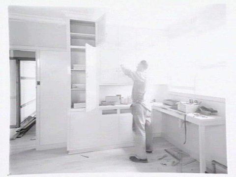 Housing Commission of Victoria pre-fabricated timber houses, showing construction in kitchen, bathroom and laundry, transfer of sections to building sites and positioning of houses on blocks at Sandringham Estate, 1949