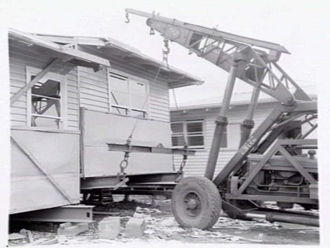 Housing Commission of Victoria pre-fabricated timber houses, showing construction in kitchen, bathroom and laundry, transfer of sections to building sites and positioning of houses on blocks at Sandringham Estate, 1949