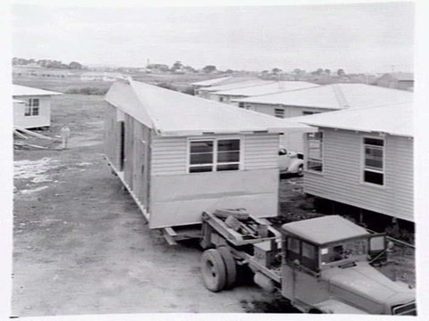 Housing Commission of Victoria pre-fabricated timber houses, showing construction in kitchen, bathroom and laundry, transfer of sections to building sites and positioning of houses on blocks at Sandringham Estate, 1949
