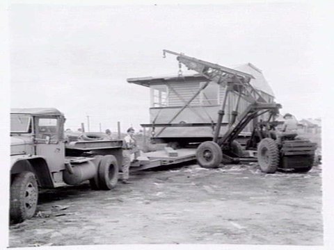 Housing Commission of Victoria pre-fabricated timber houses, showing construction in kitchen, bathroom and laundry, transfer of sections to building sites and positioning of houses on blocks at Sandringham Estate, 1949