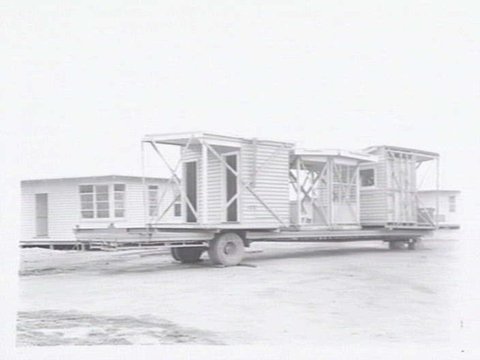 Housing Commission of Victoria pre-fabricated timber houses, showing construction in kitchen, bathroom and laundry, transfer of sections to building sites and positioning of houses on blocks at Sandringham Estate, 1949